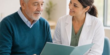 Doctor consulting elderly man with documents.