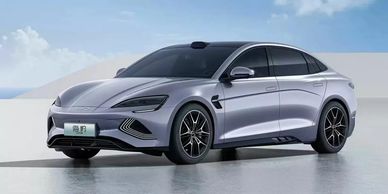 Sleek silver electric sedan with modern aerodynamic design.