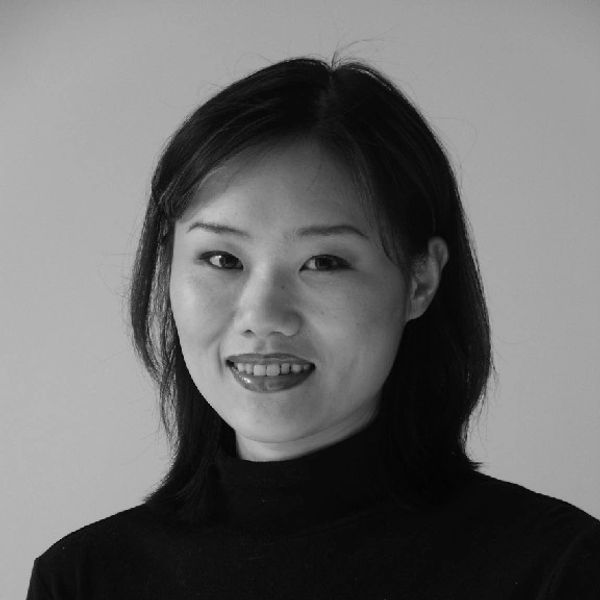 Black and white portrait of a smiling woman with shoulder-length hair.