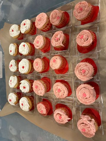 Mini strawberry and vanilla cupcakes with pink and white buttercream swirls.