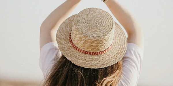 A woman with her back to us wearing a sun hat indicating reviewer Erica