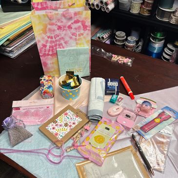 A variety of colorful stationery and personal items on a dark wooden table.