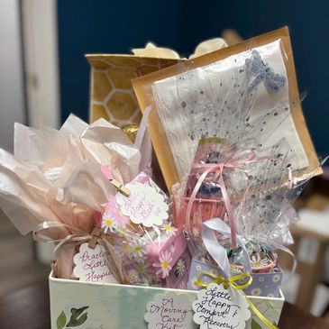 A gift basket filled with beautifully wrapped presents and decorated tags.