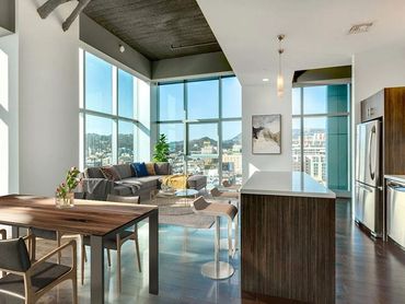 Modern living room with large windows and city views.