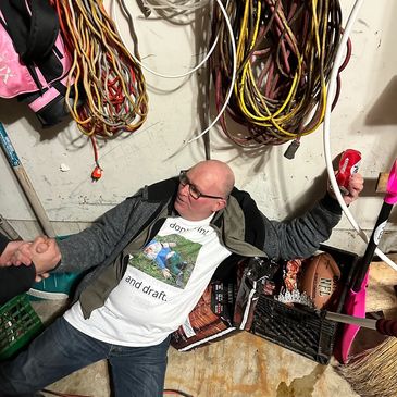 Man lying on the floor surrounded by ropes and sports equipment, shaking hands.