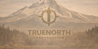 Snow-capped mountain with forest and lake, featuring TrueNorth Construction logo.