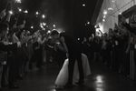 Bride and groom kissing during firework sendoff