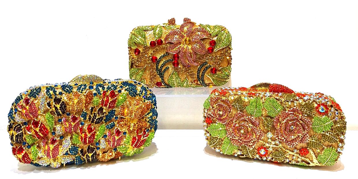 Three ornate floral beaded clutches.
