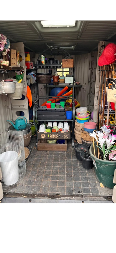 Organized gardening tools and supplies inside a storage shed or van.