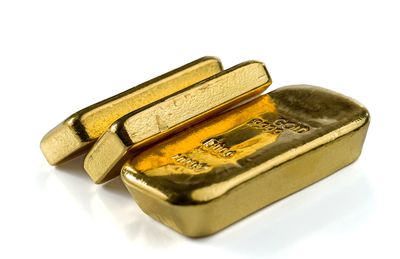 Shiny gold bars stacked together.