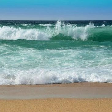 Ocean waves crashing onto a sandy beach.