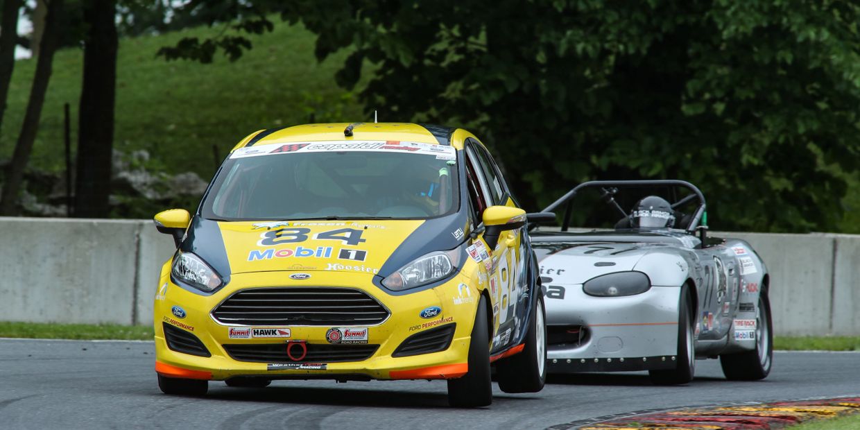 Fritz Wilke sweeps the June Sprints Hoosier Super Tour at Road America in the #84 B-Spec Ford Fiesta.  Image from the exit of turn 6 at Road America.