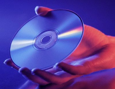 A person holding a CD