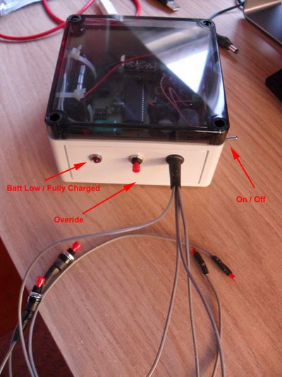 A white and black machine with wires