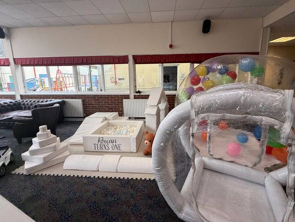Soft Play set up, with a rainbow colour Balloon Dome with personalisation including the name Rowan t