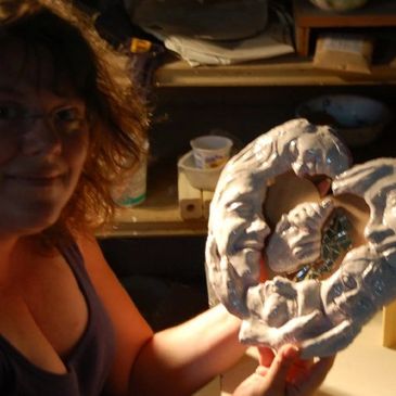 sculptor Lorna Vincent working on a clay sculpture in her studios