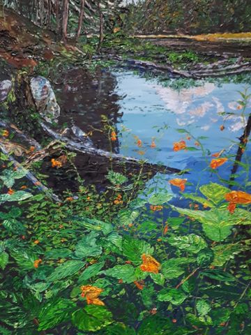 shoreline scene with bright orange flowers in the forground , middle ground is water reflecting a cl