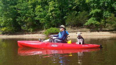 Carly Hylen fly fishes on a kayak with her dog