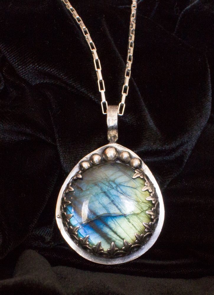 Stunning labradorite stone custom set in sterling silver setting hanging on to Sterling silver chain