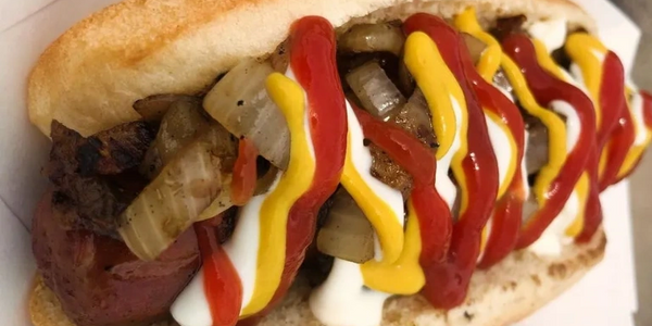 Grilled Hotdog with ketchup, mayo, and mustard with grilled onions.