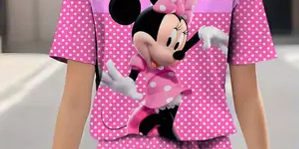 Person wearing a pink polka dot outfit with Minnie Mouse print.