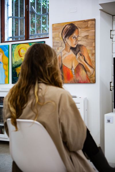 An attendee of the ITSLIQUID art show in Venice, Italy admiring “Enter to the Light”