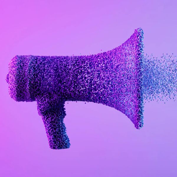 A megaphone made of tiny purple and blue particles dispersing into the air.