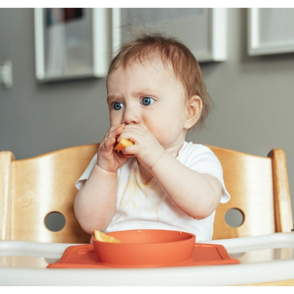 Baby eating food.