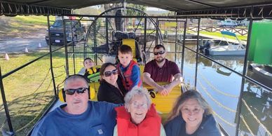 Family enjoying a boat ride on a sunny day.