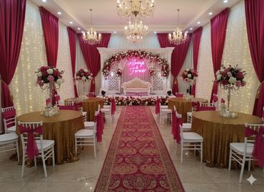 Elegant wedding reception setup with floral decorations and chandeliers.