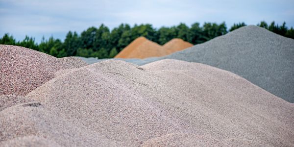 Large piles of construction sand and gravel used for asphalt production and building