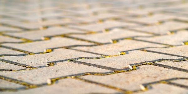 Closeup detail of gray concrete yard pavement slabs.