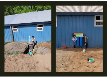 Man installs a water filtration system outside a blue building.