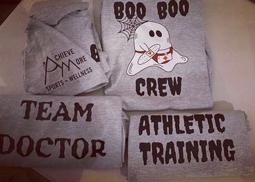 Gray shirts with themes of sports wellness, team doctor, athletic training, and a ghost mascot.