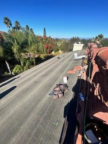 Roof flashing material laid down on a rooftop overlooking a San Diego County neighborhood,