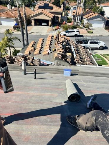 Picture of roof repair, roofing tiles laid out on a roof.
