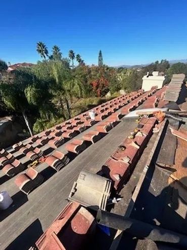 Roofing tiles are laid out symmetrically on a rooftop. Overlooking a San Diego county neighborhood.