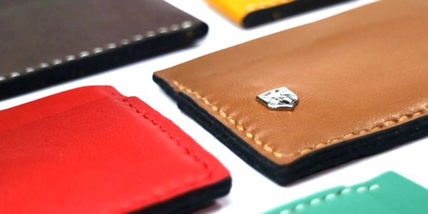 Colorful leather card holders arranged on a white surface.