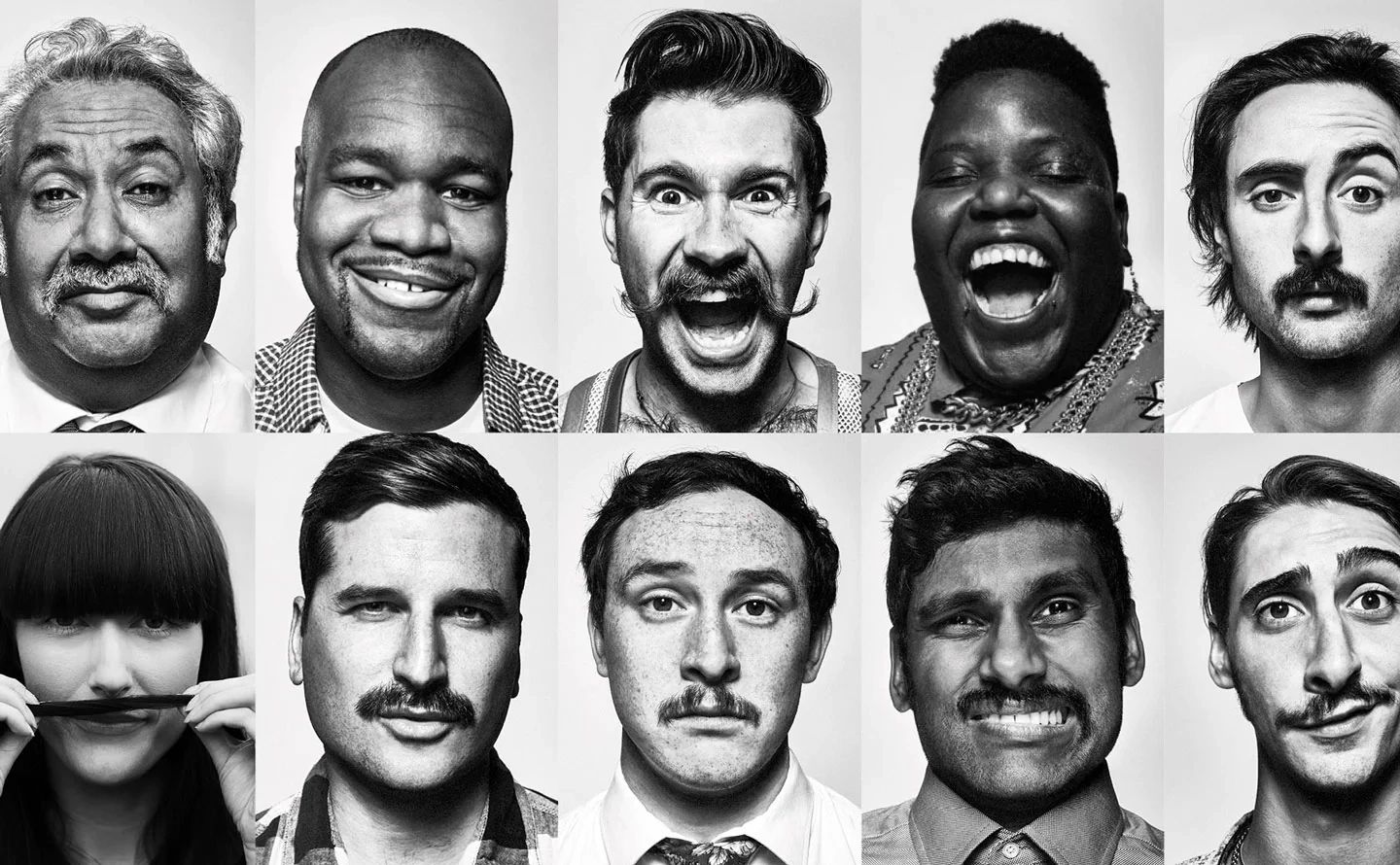 Group of men and women with moustaches looking happy. Taken from Movember, the leading charity in me