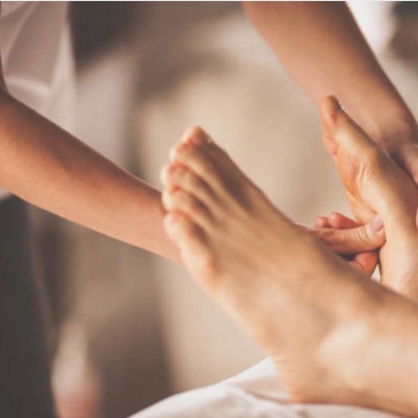 A person receiving a relaxing foot massage.