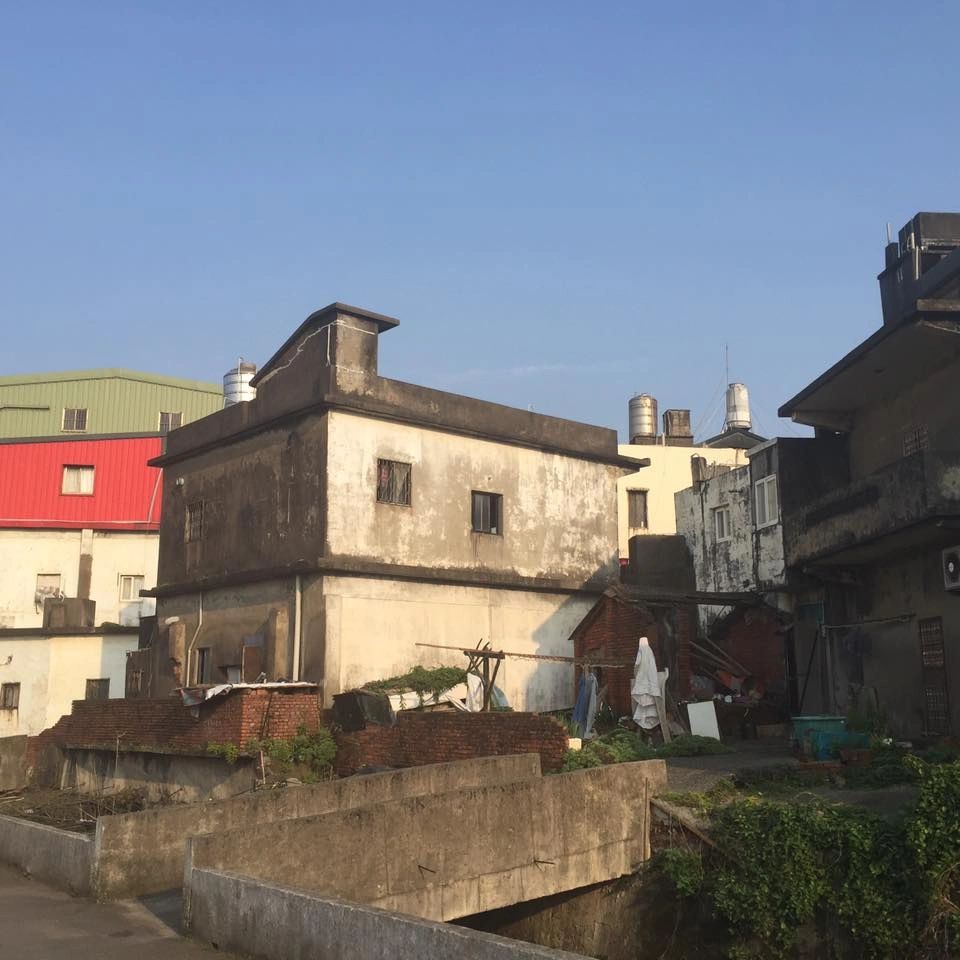 Old concrete buildings under a clear sky.