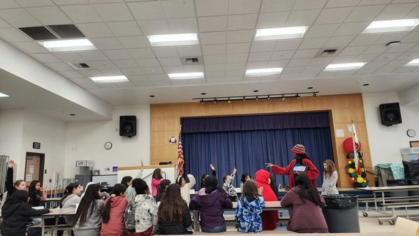 Teacher Cheyenne teaching our girls' club members about effective communication strategies.