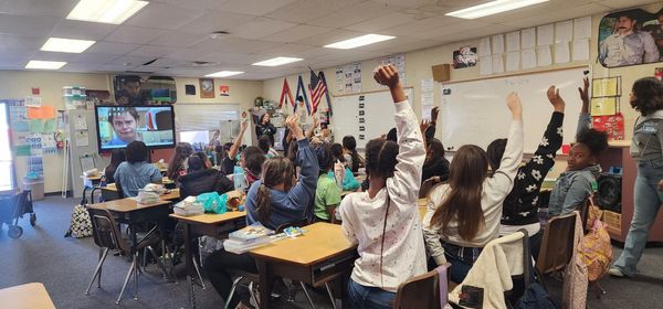Teacher Cheyenne discussing communication styles with our girls club members.