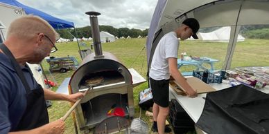 Image of fresh pizzas being cooked at a Campmates Single Parent holiday in the New Forest.