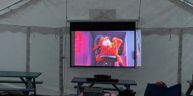Image of a movie being played on a screen at Campmates Single Parent Holidays.