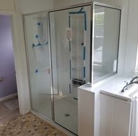 framed shower enclosure on fiberglass/composite