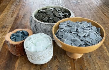 Vitreous glass mosaic tiles in wood bowls on rustic table