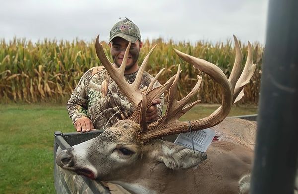 Dustin Bothman shows off his monster buck after feeding UGLYBUCK® deer mineral and deer attractant.