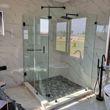 frameless glass corner shower with black fittings in a modern bathroom perfect for bathroom upgrades