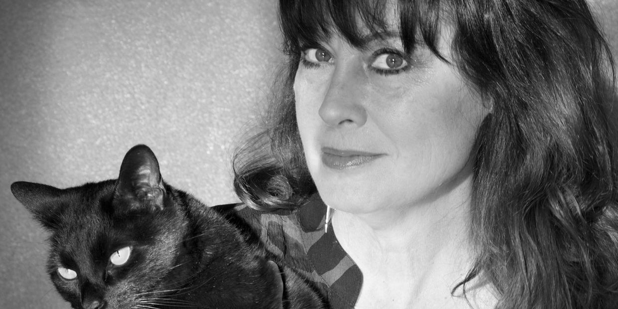 Neecy Twinem with her black cat Boo